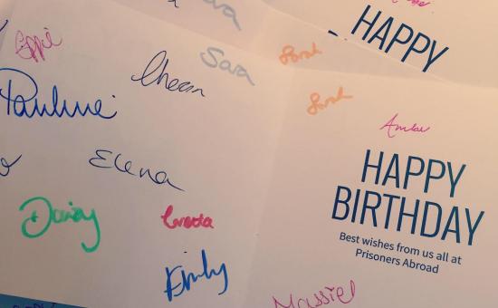 Birthday card with lots of signatures from Prisoners Abroad staff